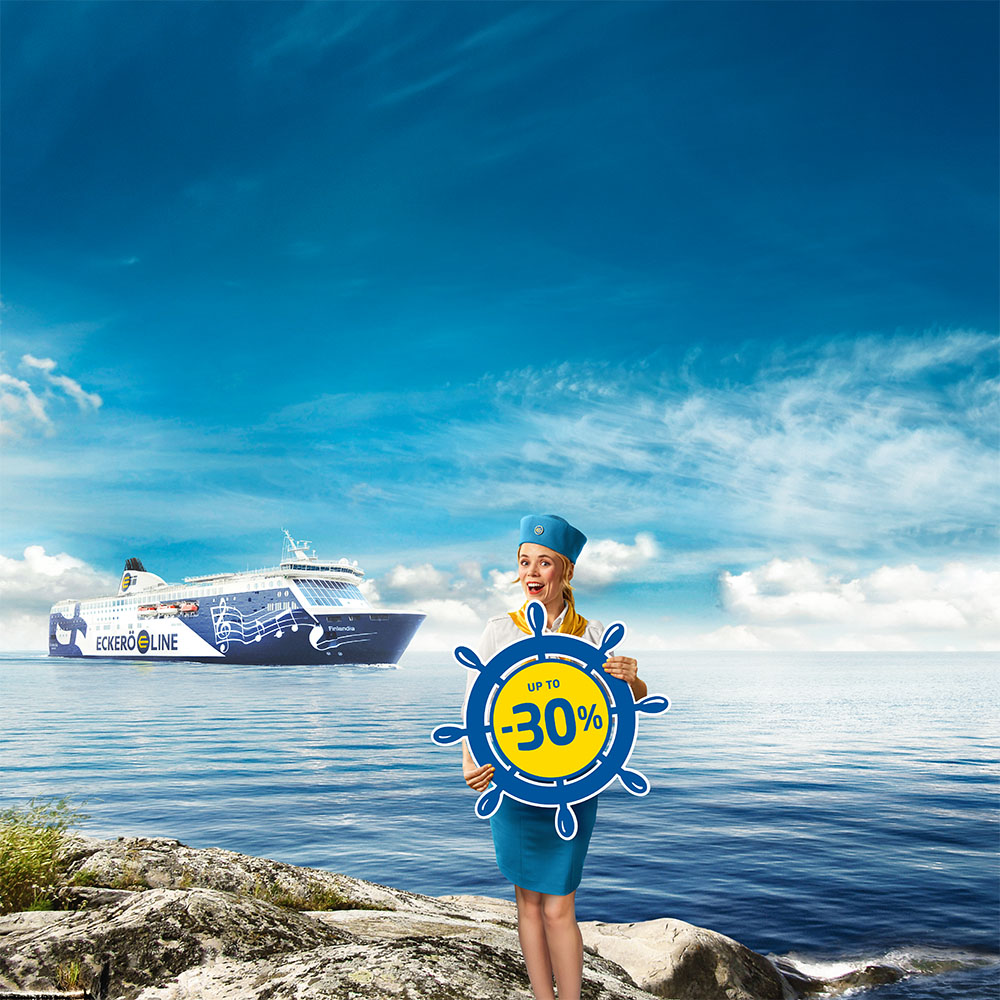 Maikki holding the sign promoting trips to Tallinn up to -30%