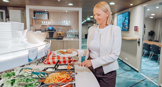 Woman picking delicacies from mini buffet