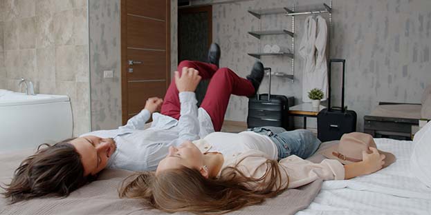 Man and a woman relaxing in hotel room