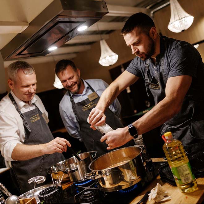 Two women laughing and cooking