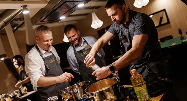Two women laughing and cooking